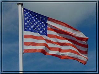 American flag on pole blue skies